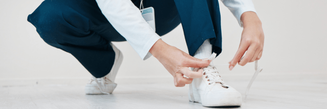 Nurse kneeling and tying their shoes