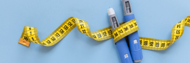Two injectors dosing pens for subcutaneous injection of antidiabetic medication or anti-obesity medication hovering over a blue background. Yellow measuring tape around the injectors.