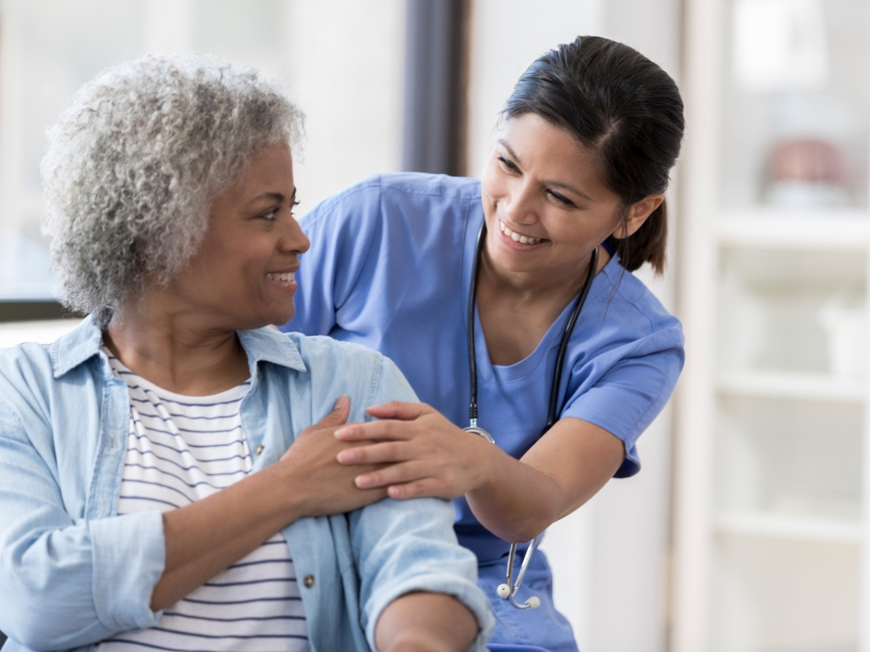Nurse Comforting Senior Woman, Showing Compassion And Care