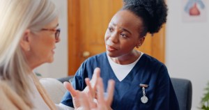 Frustrated, sad woman speaking or nurse with results in consultation for bad news or cancer. Stress, lady talking or caregiver with a depressed mature patient