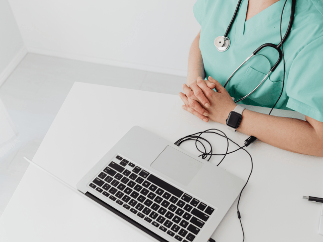 Nurse taking a virtual class with a laptop