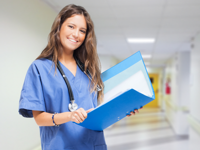 Female nurse with blue scrubs holding a file